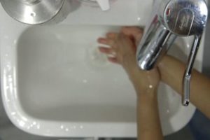 Person rinsing their hands with water