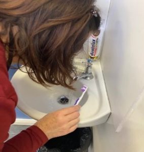 Person spitting into the sink