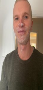 Person with soap covering their facial hair areas