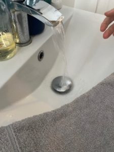 Picture of a sink with the tap running