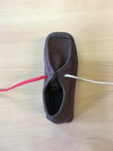 Picture shows two shoe laces, one red on the the left and one white on the right