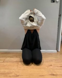 Girl putting the jumper over her head