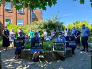 Hospital staff and League of Friends gather in the memorial garden