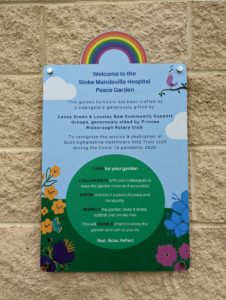 Bright and colourful Peace Garden plaque thanking the groups who fundraised