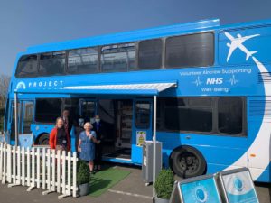 Project Wingman crew with Trust colleagues in front of the bus