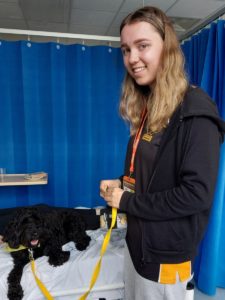 Maya on the right and Marley sitting on a patients bed on the left visiting Ward 3 (Children’s Ward)