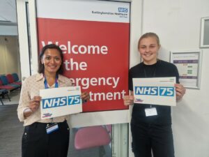 Mansi Patel, General Manager of our Emergency Department at Stoke Mandeville Hospital outside the main Emergency Department doors with a student from Holmer Green Senior School.