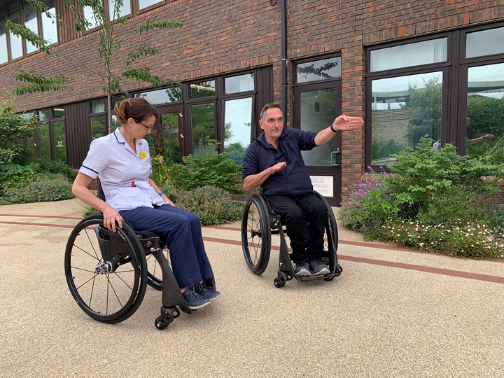 NSIC Physiotherapist Kirsten Hart tries out the Phoenix Instinct wheelchair under the direction of its designer, Andrew Slorance.
